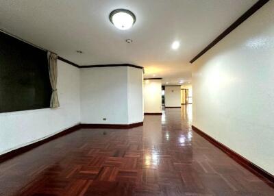 Spacious living room with wooden flooring and bright lighting