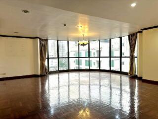 Spacious living room with large windows and city view