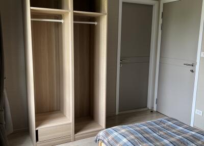 Bedroom with wooden wardrobe and bed