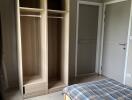 Bedroom with wooden wardrobe and bed