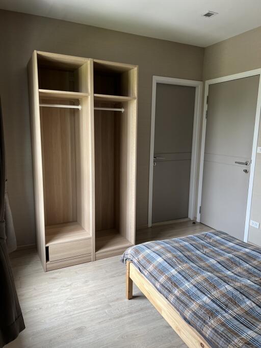 Bedroom with wooden wardrobe and bed