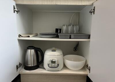 Kitchen cabinet with small appliances and dishes