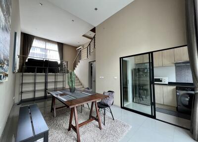 Modern loft-style living area with kitchen and dining space