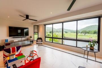 Spacious living room with large windows offering a scenic view