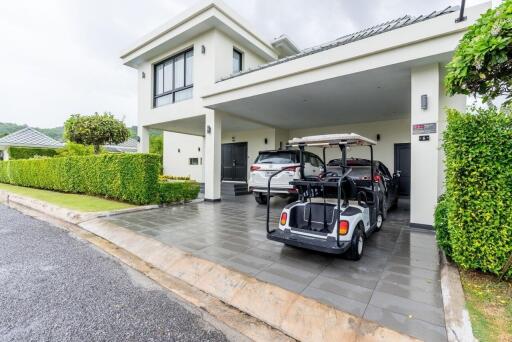 Modern house with driveway and parked cars