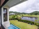 Scenic view from the property showing a lush green landscape, a body of water, and hills in the background