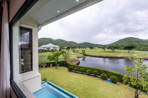 Scenic view from the property showing a lush green landscape, a body of water, and hills in the background