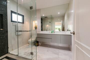 Modern bathroom with glass shower and double sink