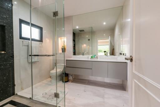 Modern bathroom with glass shower and double sink