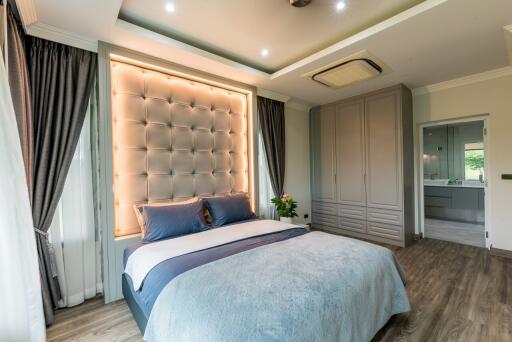 Modern bedroom with stylish lighting and ensuite bathroom