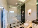 Modern bathroom with glass shower enclosure and decorative lighting