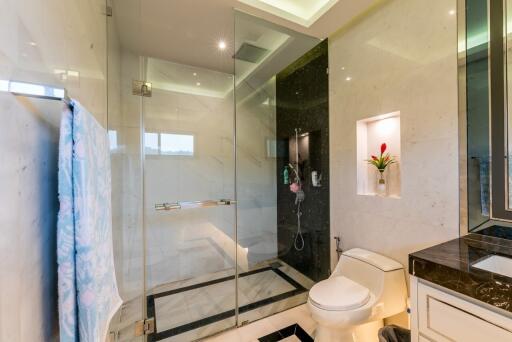 Modern bathroom with glass shower enclosure and decorative lighting