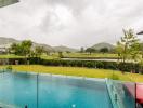 view of a swimming pool and golf course from the house