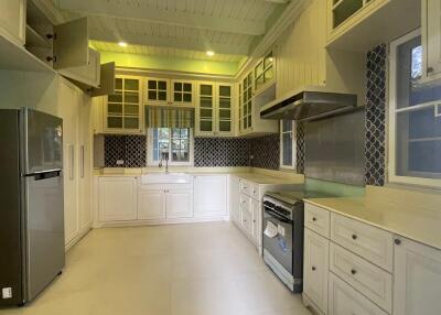 Spacious kitchen with modern appliances and cabinetry