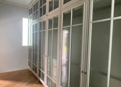 Spacious hallway with glass panel cabinets