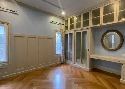 Bedroom with built-in cabinets and mirror