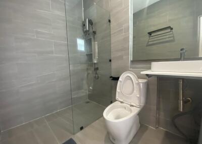 Modern bathroom with glass-enclosed shower and toilet