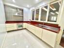 Modern kitchen with red countertops and white cabinets