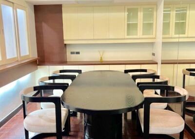 Modern dining room with dark table and cushioned chairs