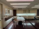 Dining room with wooden table, chairs, mirror wall, and modern lighting