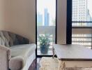 Living room with a sofa, coffee table, and access to the balcony