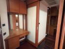 Bedroom corner with wooden desk and cabinets