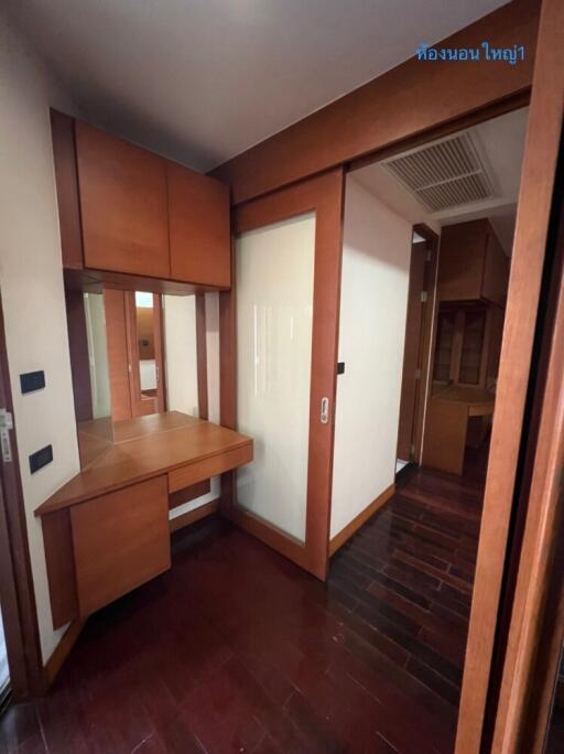 Bedroom corner with wooden desk and cabinets