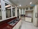 Modern kitchen with built-in cabinets and stainless steel sink