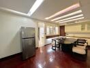 Modern dining area with a refrigerator and seating