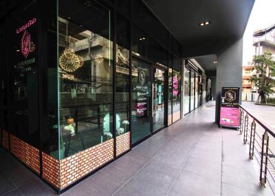 Front exterior of a commercial building with large glass windows and signage