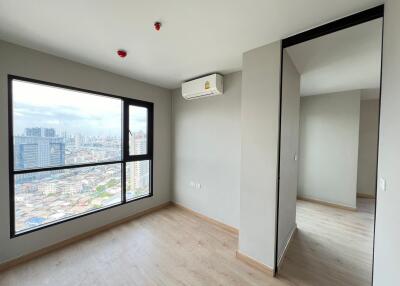 Modern bedroom with large window and city view