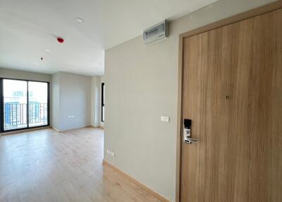 Spacious living room with large window and balcony access