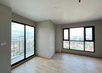 Spacious living room with large windows and city view