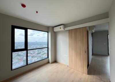 Bedroom with large window and parquet floor