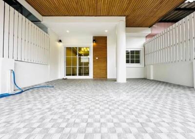 Covered outdoor area with tiled floor and modern wooden ceiling