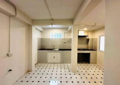 main kitchen area with tiled wall and floor