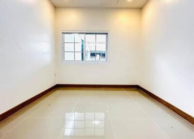 Empty bedroom with tile flooring and window