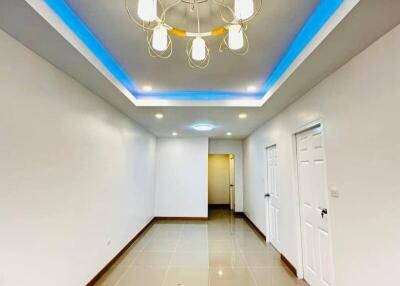 Well-lit hallway with modern lighting and tiled floor