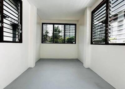 Empty room with wide windows and grey floor