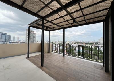 A spacious rooftop terrace with a panoramic city view