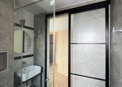 Modern bathroom with glass shower door and vanity sink