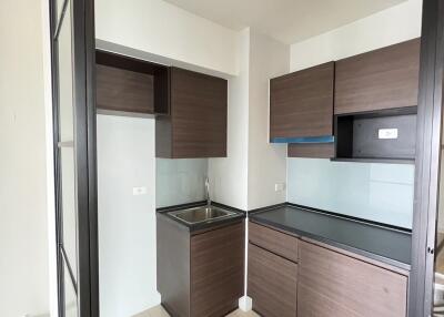 Modern kitchen with dark wood cabinetry and glass partitions