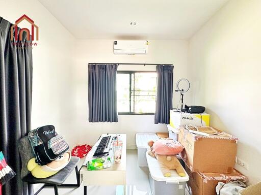 Small room with desk and storage boxes