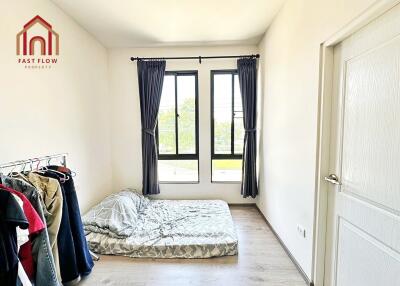 Bedroom with simple furnishing and large windows