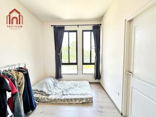 Bedroom with simple furnishing and large windows