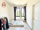 Bedroom with simple furnishing and large windows