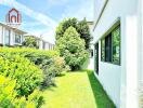 Outdoor garden with lush greenery and adjacent building