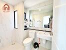 Modern bathroom with white fixtures and vanity mirror