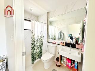 Modern bathroom with shower, toilet, and sink