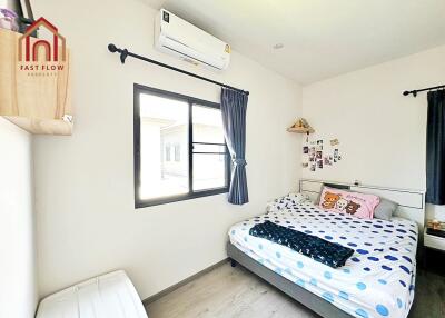 Cozy bedroom with double bed, window, and air conditioning